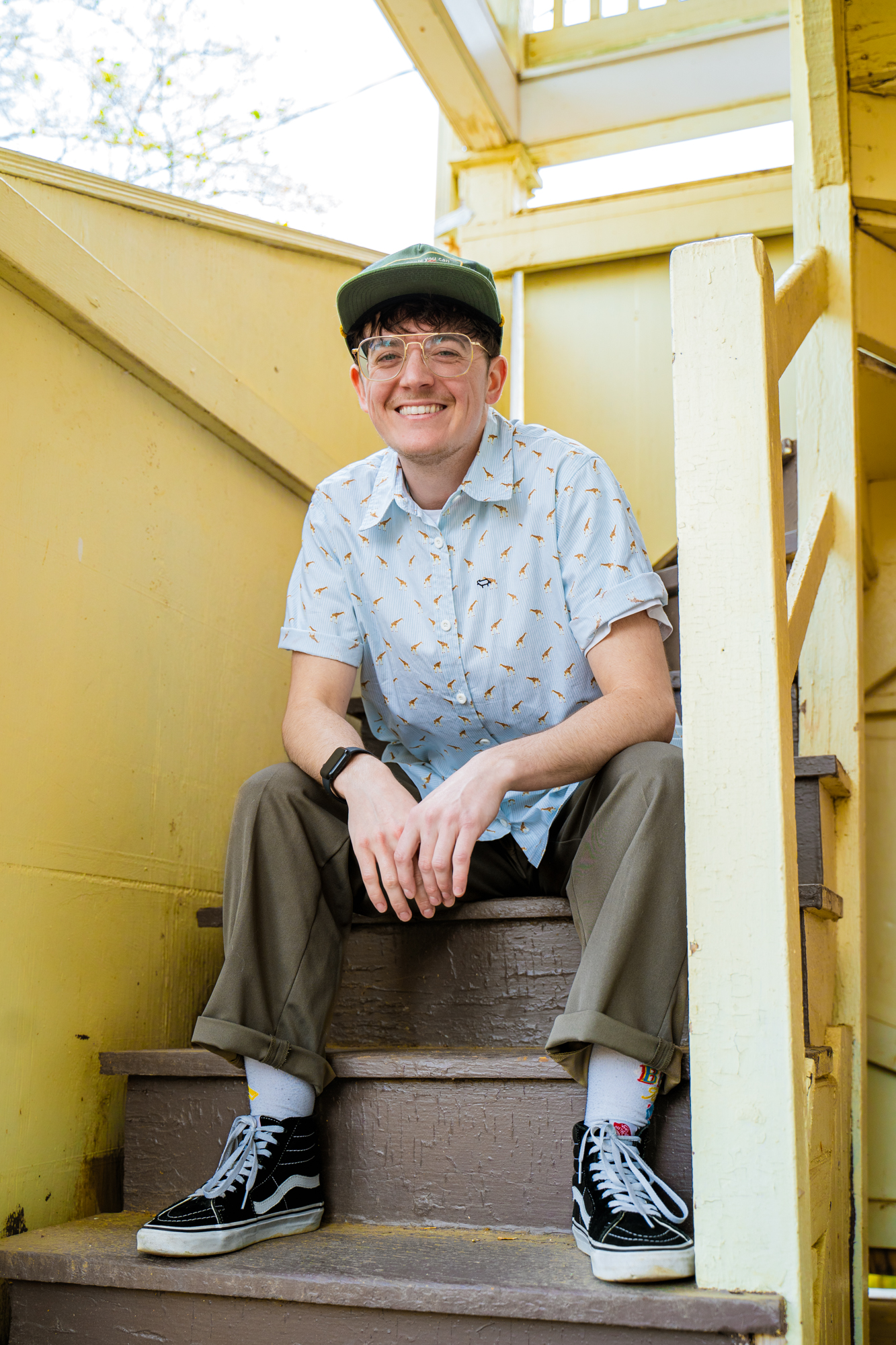 Edmund Boxley sits on a set of stairs smiling at the camera.
