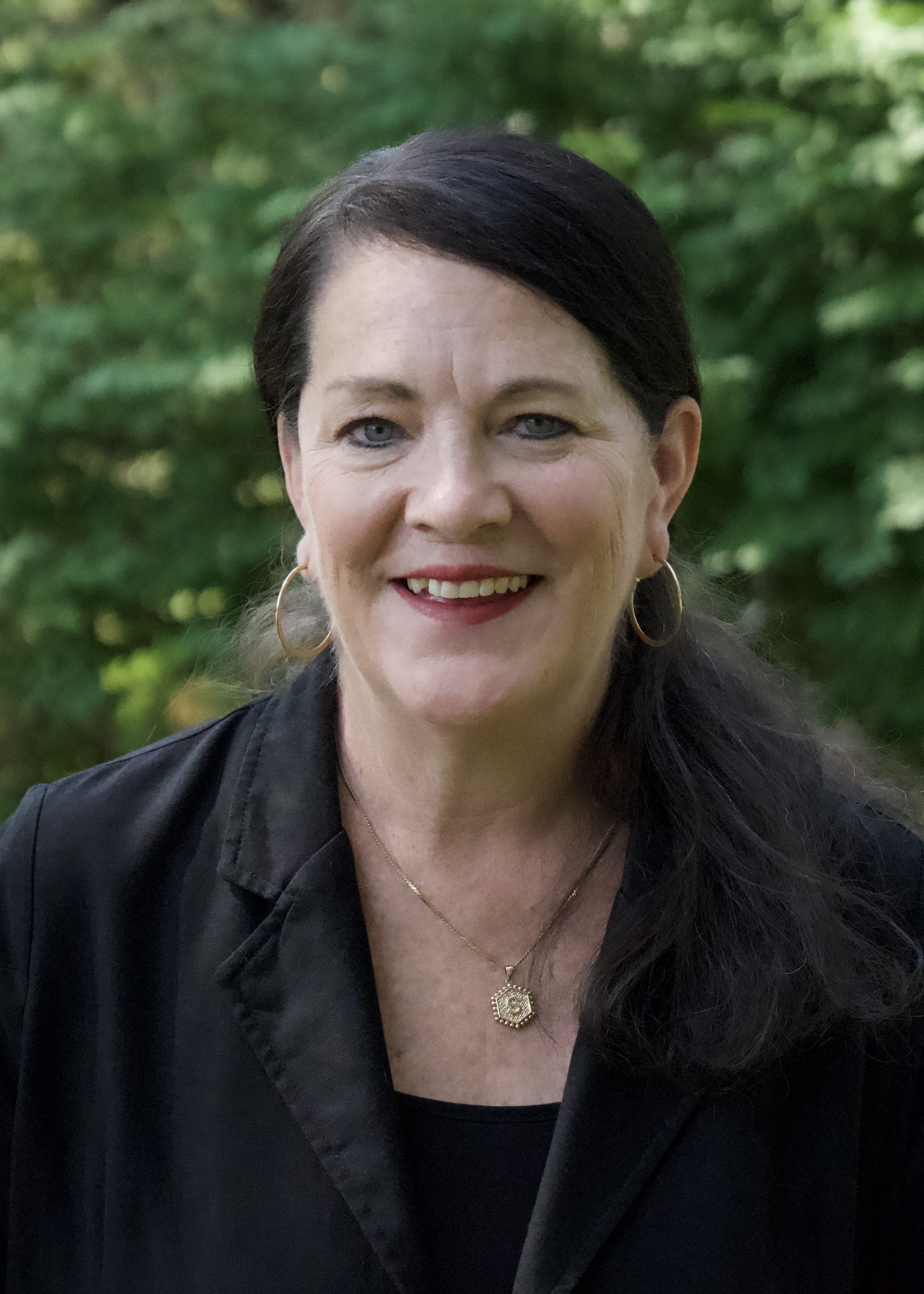 A headshot of Stacey Kalbach in a black shirt.